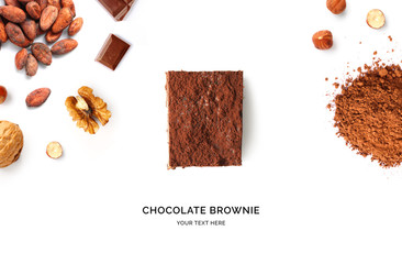 Creative layout made of brownie, walnut, hazelnut, chocolate and cacao powder on the white...