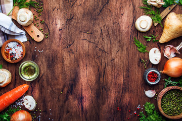 Obraz na płótnie Canvas Ingredients for cooking green lentils with mushrooms and vegetables, spices and herbs, vintage wooden kitchen table background, place for text. Vegan or vegetarian food, clean food concept. 