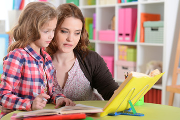 Portrait of cute little girl doing homework