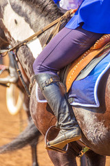 A close-up of the rider's body in the stirrups.