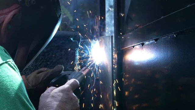 man stick welding in the field,