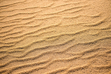 Sand of a beach with wave patterns