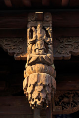 carved figures in front of the door