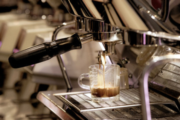 Espresso shot from coffee machine in coffee shop,Coffee maker in coffee shop