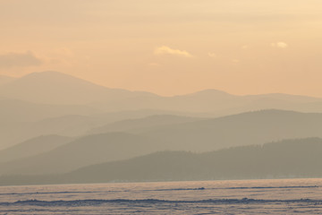 panorama winter mountain,misty hills mountain tops in pink dawn