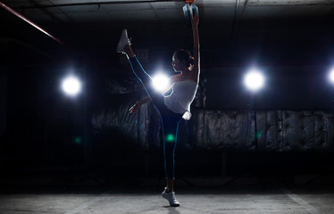 Asian Tan Skin Fitness woman exercise Stretch arms legs warm up Smoke Dark background environment, studio lighting rim back light copy space, concept Women Can Do Sport 6 packs