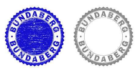 Grunge BUNDABERG stamp seals isolated on a white background. Rosette seals with grunge texture in blue and grey colors. Vector rubber imitation of BUNDABERG tag inside round rosette.