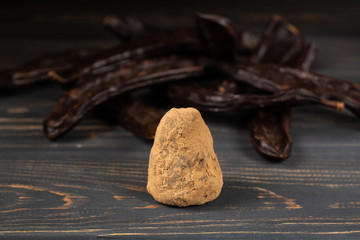 Healthy raw vegan sweet homemade candy on a wooden table background with carob