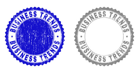 Grunge BUSINESS TRENDS stamp seals isolated on a white background. Rosette seals with grunge texture in blue and gray colors. Vector rubber overlay of BUSINESS TRENDS tag inside round rosette.