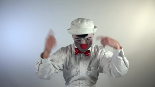 Emoji Clown. A silly clown gets crazy, laughing exaggeratedly and hitting his head.