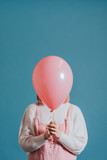 Girl with a pink helium balloon