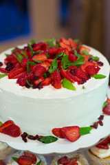 a wedding cake with cream and strawberries