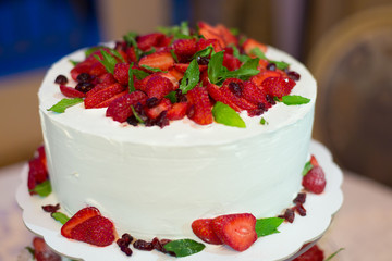 a wedding cake with cream and strawberries