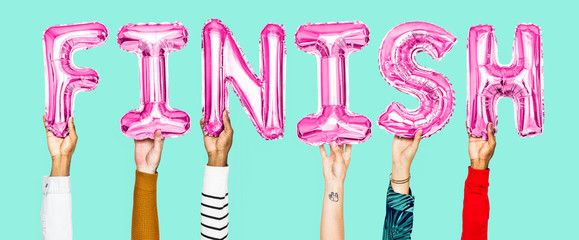 Hands holding finish word in balloon letters