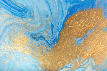 Blue and gold marbling pattern. Golden marble liquid texture.