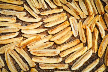 Dried banana background / Organic banana long slice dry on bamboo threshing basket for sun drying