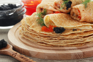 Russian pancakes with red and black caviar
