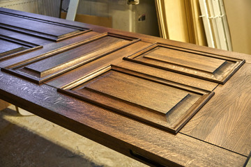 Wood door manufacturing process. Door leaf, painted in dark color. Furniture manufacture.