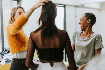 Stylists helping a model get ready