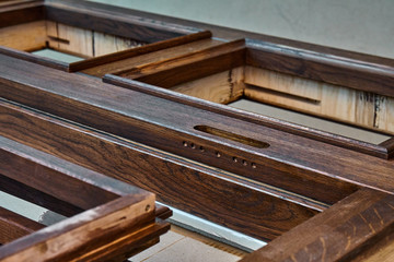 Wood door manufacturing process. Door frame, painted in dark color. Furniture manufacture.
