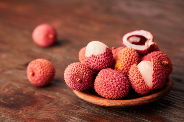 Fresh lychees close up on wooden background