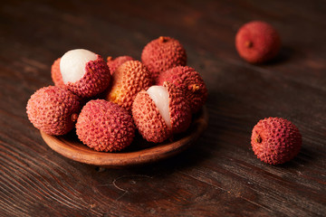 Fresh lychees close up on wooden background