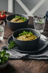 Split Pea Soup with Vegetables on a wooden background, selected focus