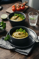 Split Pea Soup with Vegetables on a wooden background, selected focus