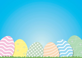 Decorative Easter eggs on green grass, with copy space