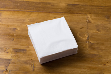 paper napkin on wooden background.