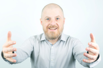 Bearded man stretches his arms forward