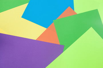 Colorful background. Sheets of colourful paper on the desk top view. Abstract background