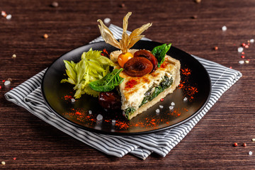 French cuisine concept. Closed Kish with spinach.