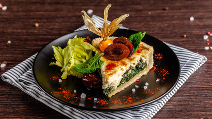 French cuisine concept. Closed Kish with spinach.