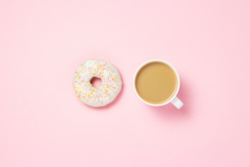 Cup with coffee or tea. Fresh tasty sweet donut on a pink background. Bakery concept, fresh pastries, delicious breakfast, fast food, coffee shop. Flat lay, top view.