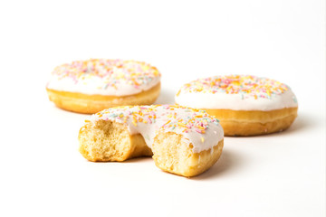 Bitten fresh tasty donut on a white background. Bakery concept, fresh pastries, delicious breakfast.