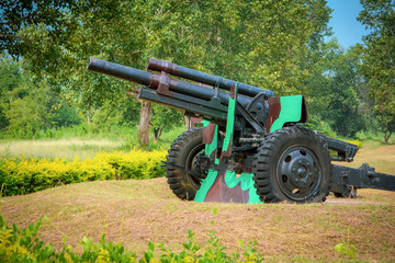 Old artillery cannon gun camouflage pattern / ordnance for soldier warrior in the world war in the park