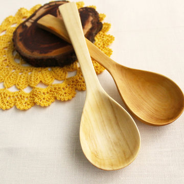 Wooden spoons on isolated background, crocheted yellow lace, napkin. The idea of healthy food, handmade, homemade food, needlework
