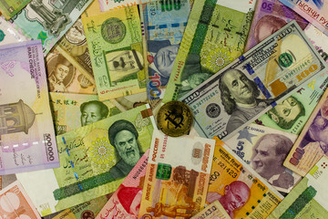 Bitcoin against  background of banknotes of different countries.