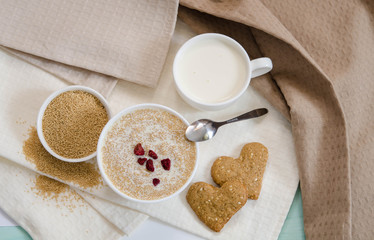 Healthy breakfast. Sesame dry cookies in the form of heart porridge of amaranth with strawberries and yogurt.