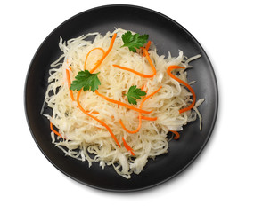 pickled cabbage and carrots in black plate isolated on white background. top view