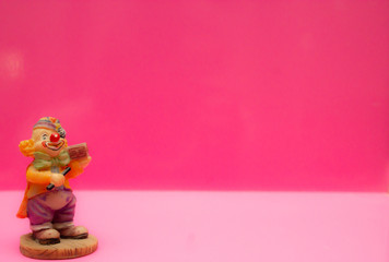 Children's cute toys figurines on a pink background