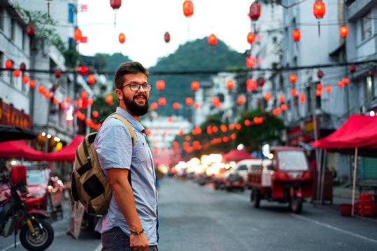 Traveler exploring Asian food market street