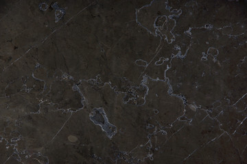 The texture of natural stone marble dark brown with patterns