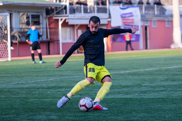 soccer player kicking ball