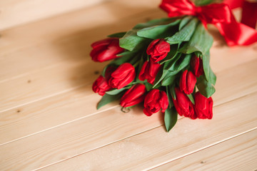 Beautiful Rustic background with Red Tulips. Colorful Card for Mothers Day, Birthday, International Women's Day March 8