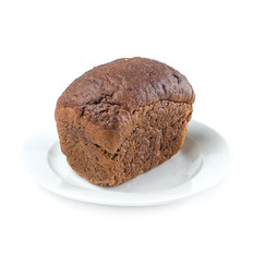 a loaf of rye bread on a white plate on white background