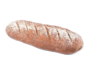 prolonged loaf of brown rye bread (bloomer) with flour sprinkled on top on a white plate on white background