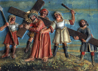 Fototapeta na wymiar Simon of Cyrene carries the cross