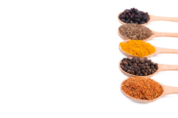 Spices mix on wooden spoons isolayed on a white background. Top view